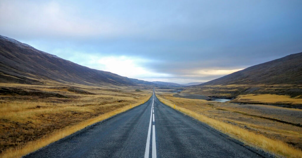 Straight open road leading into the horizon, symbolizing new beginnings and a clear path forward for entrepreneurs.